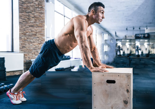 Man performing slant calf raises on a box